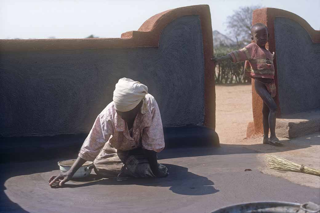 Woman polishing floor, Mahalapye