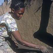 Girl plastering a house, Naledi