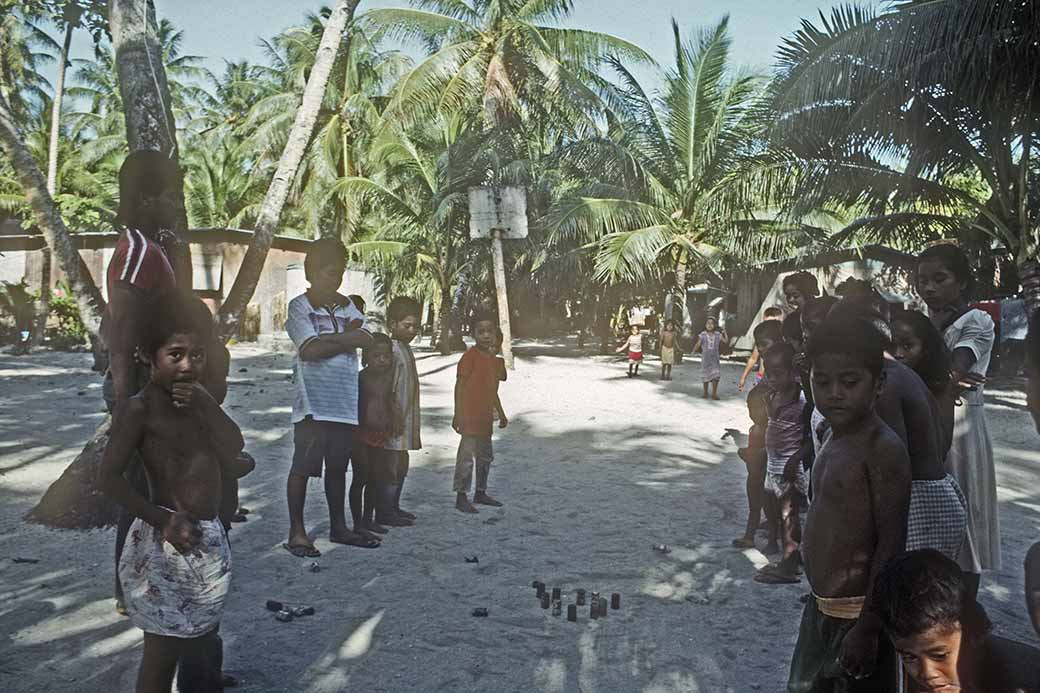 Chidren playing with tin cans