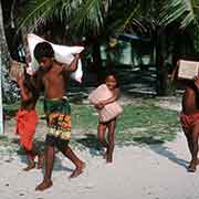 Boys carrying supplies, Onari