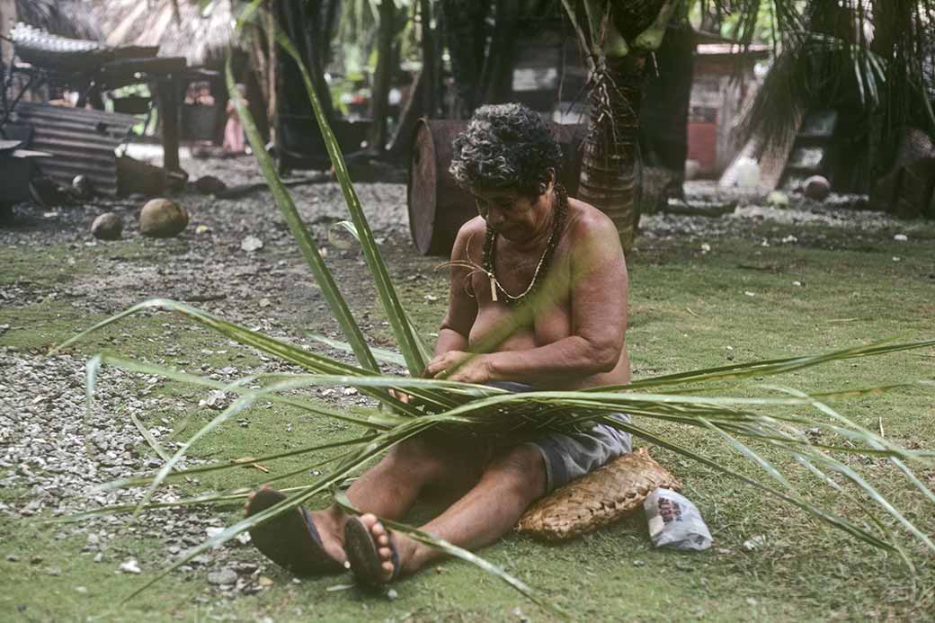 Woman weaving pandanus mat