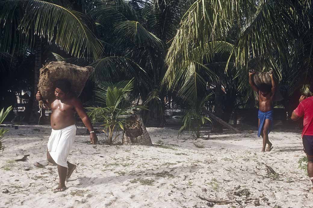 Men carrying copra