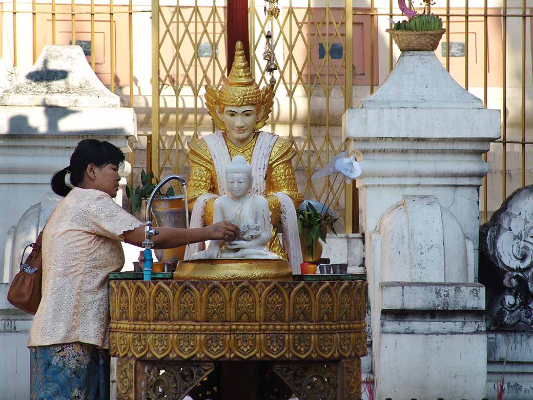 Worshiper pouring water