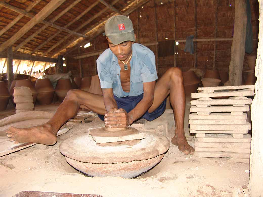 Working a pottery wheel