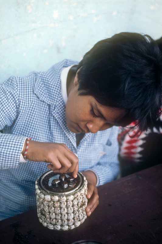 Girl decorating a tin