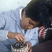 Girl decorating a tin