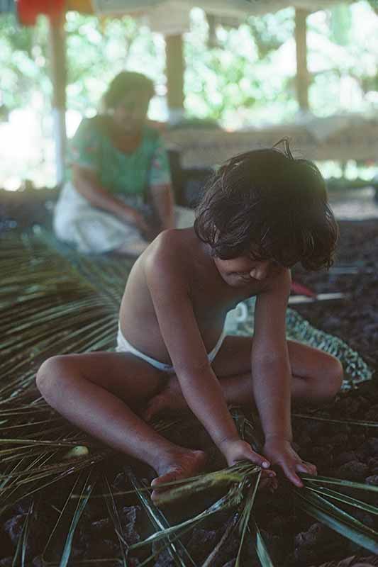 Girl weaving a mat