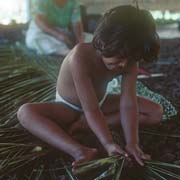 Girl weaving a mat