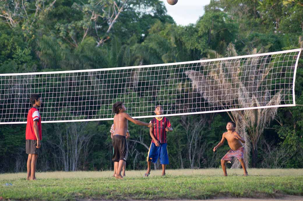 Boys playing volleyball, Palumeu