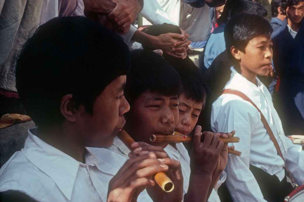 Boys playing flutes