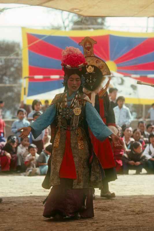 Woman and masked dancer