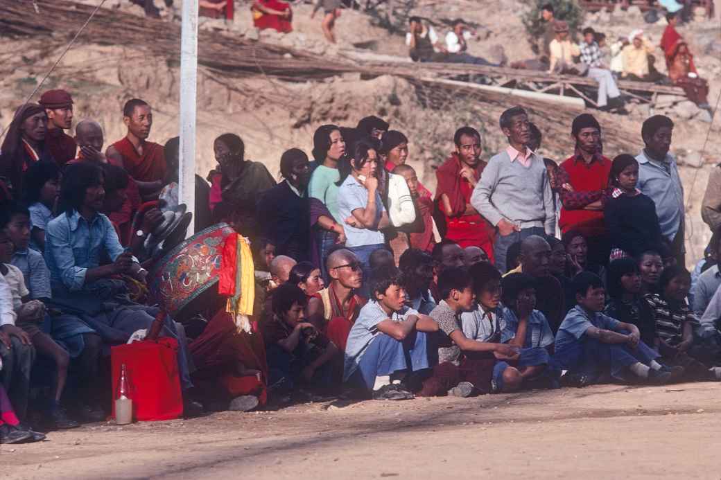 Playing the 'Dhyangro' drum and crowd