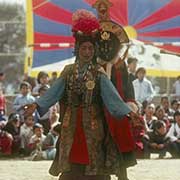 Woman and masked dancer