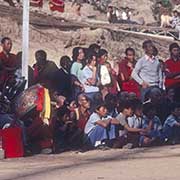 Playing the 'Dhyangro' drum and crowd